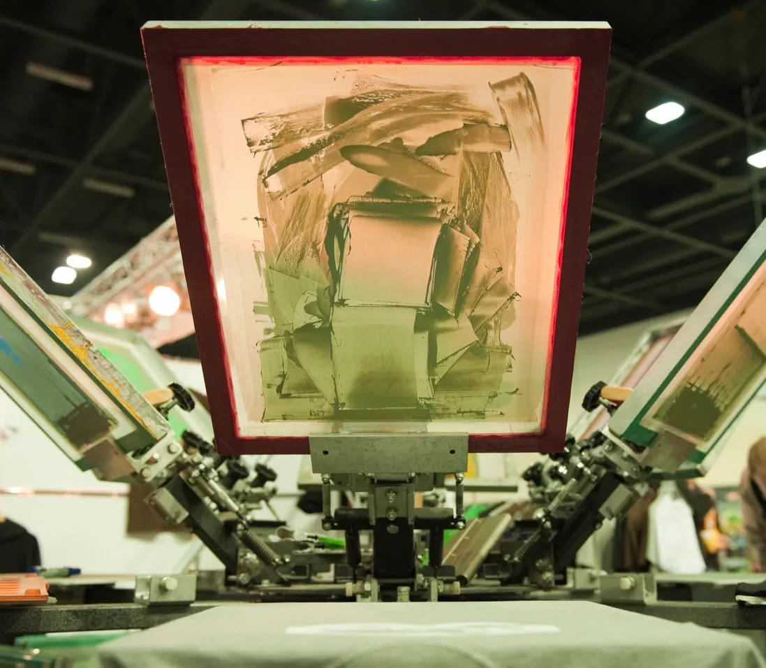 A screen printing machine with the image of a person in it.