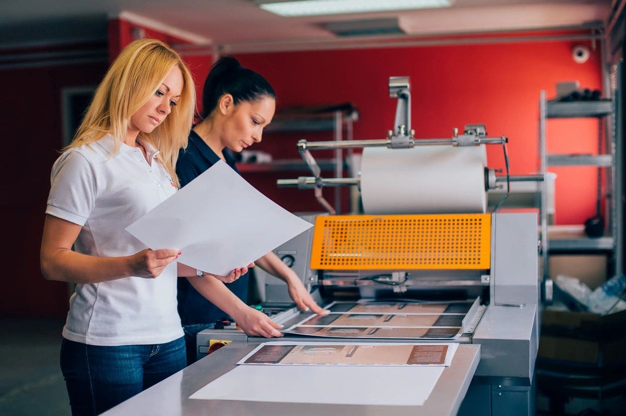 Two women are working in a printing shop.