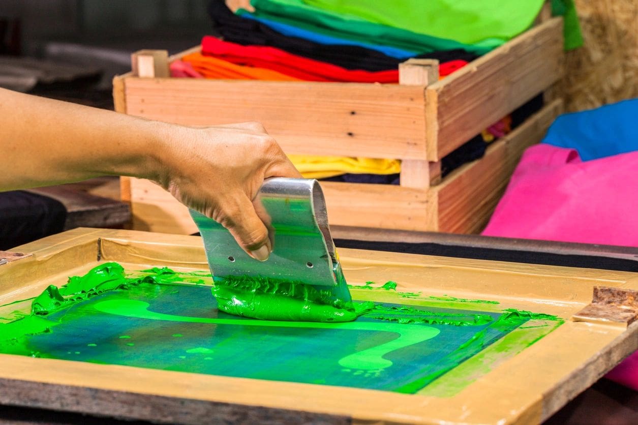 A person is using green liquid to make something.